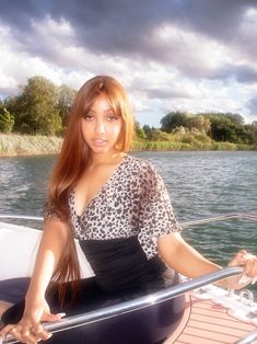 a beautiful woman sitting on top of a boat