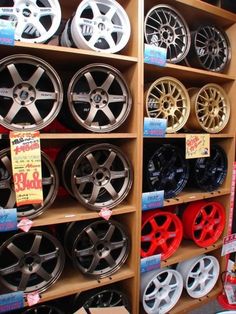 the shelves are filled with various types of wheels and rims on display for sale