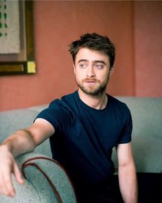 a man sitting on top of a blue couch