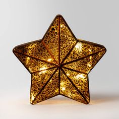 a lighted star shaped object on a white surface