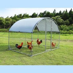 several chickens in a chicken coop on the grass