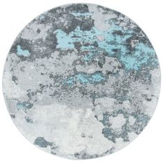 a round rug with blue and gray paint on the top, in front of a white background