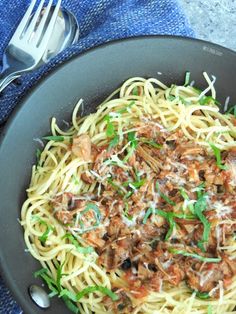 pasta with meat and parmesan cheese in a skillet on a blue towel