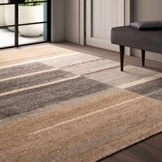 an area rug in the corner of a living room with a bench and sliding glass door