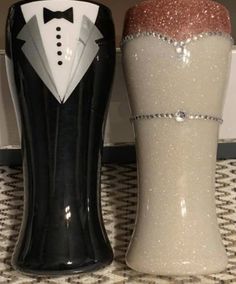 two salt and pepper shakers decorated with tuxedos