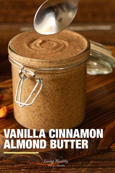 vanilla cinnamon almond butter in a glass jar with a spoon sticking out of the top