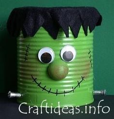 a green tin can with a creepy face and black hair on it's head