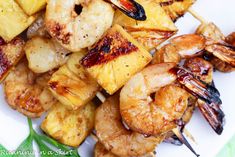 grilled shrimp and pineapple skewers on a white plate