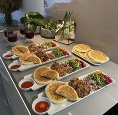 several plates of food on a counter with sauces and condiments next to them