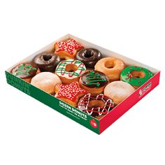 an open box of assorted donuts with frosting and sprinkles