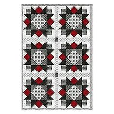 a black and white quilt with red accents