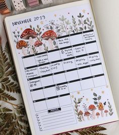 a planner with mushrooms on it next to some leaves and dices in the shape of numbers