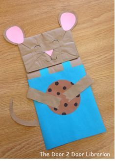 a paper bag shaped like a mouse holding a cookie