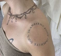 a woman with a tattoo on her chest has a message written in the middle of it