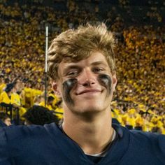 a man with his face painted like a football player