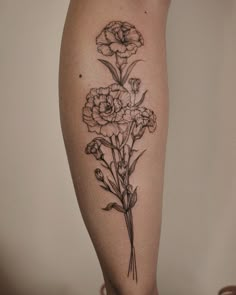 a woman's leg with flowers on it