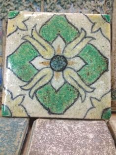 several different colored and patterned tiles sitting on top of each other