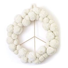 a peace sign made out of white pom - poms