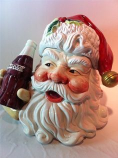 a ceramic santa clause holding a beer bottle