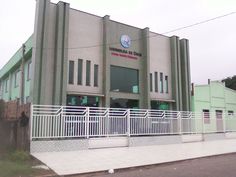 a large building with a white fence in front of it