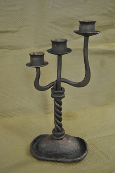 a metal candelabra sitting on top of a table