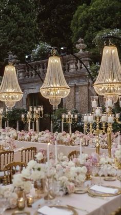 the tables are set up with chandeliers and flowers