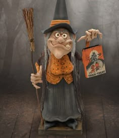 a statue of an old witch holding a trick bag