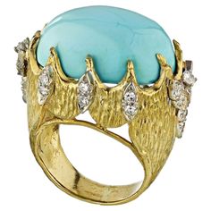 Beautiful 1970's ring crafted in 18k yellow gold set with dome oval turquoise gem. 26 diamonds on the outer frame. Gems: Turquoise, Diamonds Metal Type: 18K Yellow Gold Metal Weight: 21.0 gr. Ring Size 6.5 ABOUT TURQUOISE: Turquoise is an opaque, blue-to-green mineral that is a hydrous phosphate of copper and aluminium. It is rare and valuable in finer grades and has been prized as a gem and ornamental stone for thousands of years owing to its unique hue. SPIRITUAL MEANING: Turquoise, the fascinating sea-green stone of the classical era, speaks for wisdom, protection, good fortune, tranquility, and hope. Ancient people believed in its intense power to protect, its peaceful energy and its connection with enduring love. Gold Turquoise Ring, Turquoise Diamond Rings, Turquoise Gem, Turquoise Gold Ring, Emerald Cut Diamond Ring, Yellow Gold Setting, Spiritual Meaning, Ring Crafts, Domed Ring