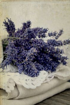 a bunch of purple flowers sitting on top of a table