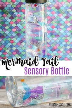 mermaid tail bottle filled with sand and seaweed in front of a colorful fish background