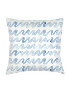 a blue and white pillow with wavy waves on the front, against a white background