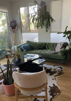 a living room filled with furniture and plants