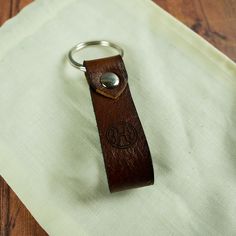 a leather keychain sitting on top of a table