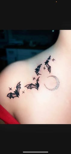 the back of a woman's shoulder with bats and stars on it