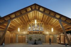 the inside of a wooden building with lights on