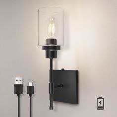 a wall mounted light with two plugs attached to it