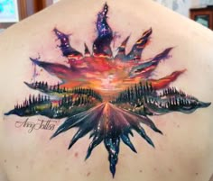 the back of a woman's shoulder with an artistic painting on it