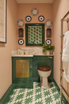 a bathroom with green and white decor on the walls