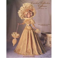 a crochet doll is wearing a yellow dress and hat