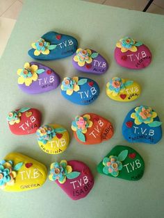 the rocks have flowers on them and are decorated with name written in different colors, shapes and sizes