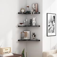 a living room with three black shelves on the wall