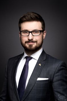 a man wearing glasses and a suit