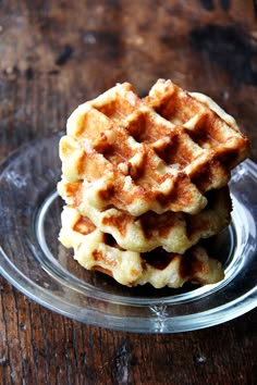 three waffles stacked on top of each other in a glass plate