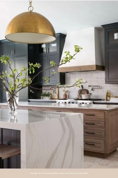 a modern kitchen with marble counter tops and wooden cabinets, along with an island in the middle