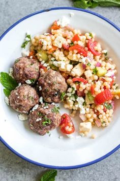 a white plate topped with meatballs and vegetables