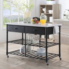 a kitchen island with two drawers and an open shelf on the side, in front of a window