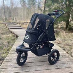 the stroller is sitting on the wooden walkway