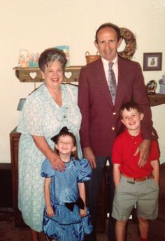 an older man and two young children posing for a photo