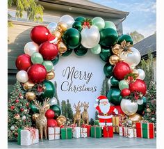 an outdoor christmas display with presents and santa clause