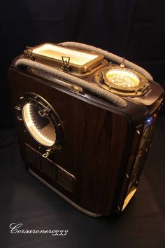 an old fashioned radio sitting on top of a wooden table next to a black wall